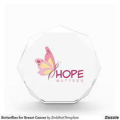 a glass award with the words hope matters written on it and a butterfly in pink