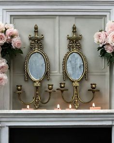 there are two mirrors on the mantle with candles