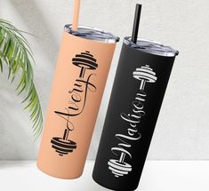 two black and pink tumblers sitting next to each other on top of a table