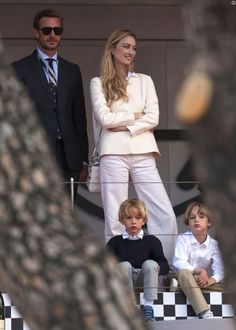 a man and woman standing next to two children