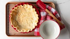 a pie sitting on top of a pan next to a bowl