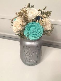 a vase filled with flowers sitting on top of a white counter next to a door