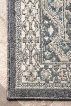 an area rug is shown on the floor with tile in the background and light blue tones