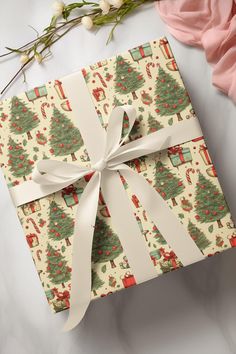 a present wrapped in wrapping paper with a white ribbon