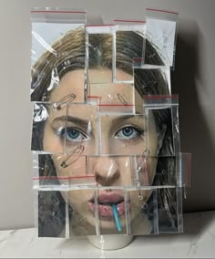 a woman's face is surrounded by plastic blocks