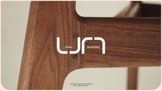 the logo for urban furniture company is shown in white letters on a wooden chair seat