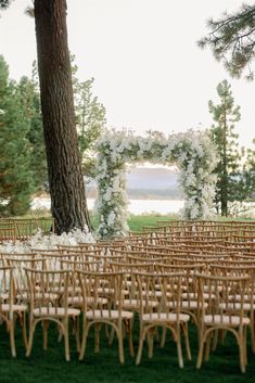 an outdoor ceremony setup with chairs and flowers