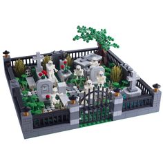 a lego cemetery with tombstones and trees