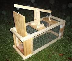 a small wooden chicken coop in the grass