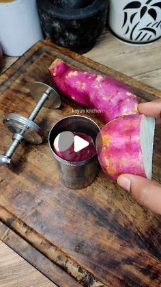 a person is peeling an onion on a cutting board