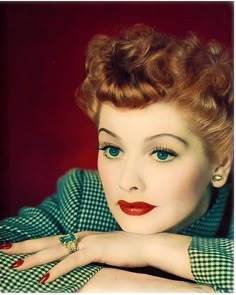 an old photo of a woman with red hair and blue eyes posing for the camera