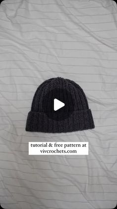 a black beanie hat sitting on top of a white sheet with the text, video & free pattern at virochets com