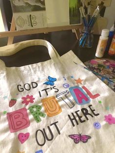 a canvas bag with the words, god it's beautiful out here on it