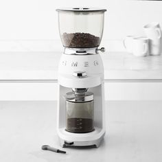 a white coffee maker sitting on top of a counter