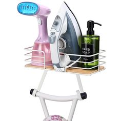 an ironing board with soap, shampoo and hand soap on it next to a hairdryer