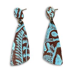 This stunning Tooled Leather Stud is a wild west inspired earring that goes from day-to-night with the greatest of ease. Featuring traditional tooling, they are eye-catching and fun to wear. Inspired by our favorite cowgirl Beth Dutton, these studs will make you feel instantly badass. The turquoise is so rich in color, you won't be able to stop showing them off. OVERVIEW This listing is for one pair of earrings. Color: Brown and Turquoise Tooled Leather Material: Tooled leather on nickel-free me Brown And Turquoise, Beth Dutton, Tooled Leather, Earrings Color, Leather Tooling, Wild West, Leather Material, Make You Feel, Cowboy Boots