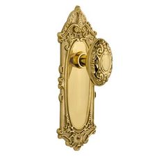 an ornate brass door handle on a white background