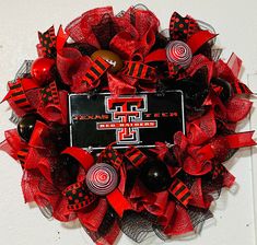 a red and black wreath with a texas tech logo on it