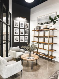 a living room filled with furniture and pictures on the wall