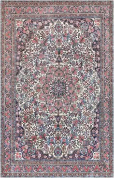 an antique persian rug with floral design on the center and blue, pink, red and white colors