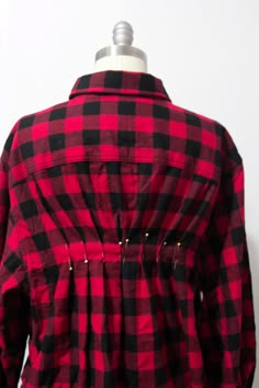 a red and black checkered shirt on a mannequin