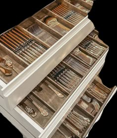 the drawers are full of silverware and other things to be seen in this image