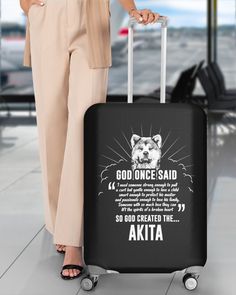 a woman holding a suitcase with the words akita on it and an image of a tiger