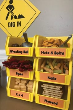 a yellow bin filled with lots of food next to a sign