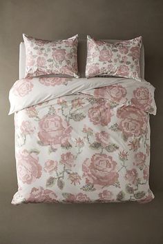 an image of a bed with pink flowers on it