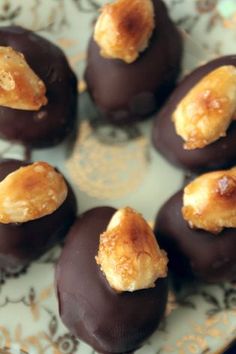 chocolate covered pastries on a plate with gold trimmings and crumbs