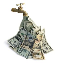 a faucet filled with lots of money sitting on top of a pile of bills