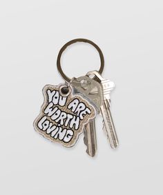 a keychain with the words you are worth giving written on it and two keys attached