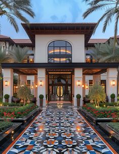 the front entrance to a luxury home at dusk