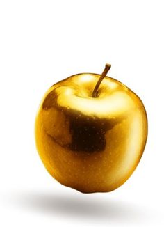 an apple that is shiny gold on a white background