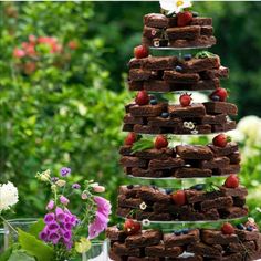 a cake tower made out of brownies and strawberries