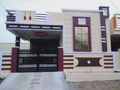 a building with a black gate and red trim