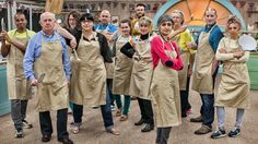 a group of people in aprons standing together