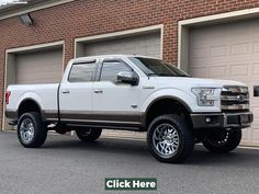 a white truck parked in front of a brick building