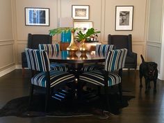 a dining room table with blue and white striped chairs