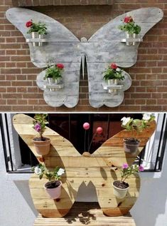 the butterfly is made out of pallets and has potted plants in it, along with