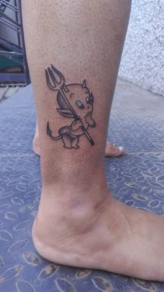 a person with a tattoo on their foot holding a knife and fork in the other hand