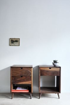 two wooden nightstands side by side against a white wall