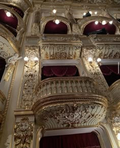 an ornately decorated building with red curtains