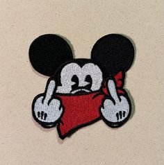 a mickey mouse iron - on patch with a red pillow