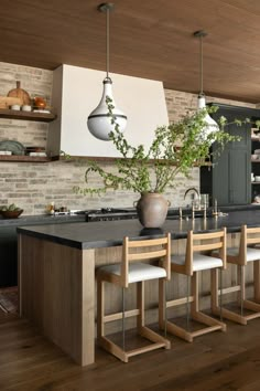 a kitchen with an island and wooden floors