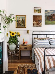 a bedroom with sunflowers and pictures on the wall