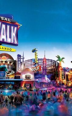 the city walk sign is in front of an amusement park with people walking around it