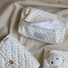 the baby's diaper is next to its mother's purse and teddy bear