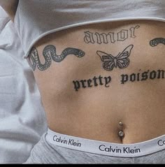 a woman with tattoos on her stomach and the words pretty prison written in black ink