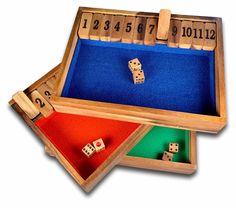 three wooden dices in a box with numbers on the sides and one is missing